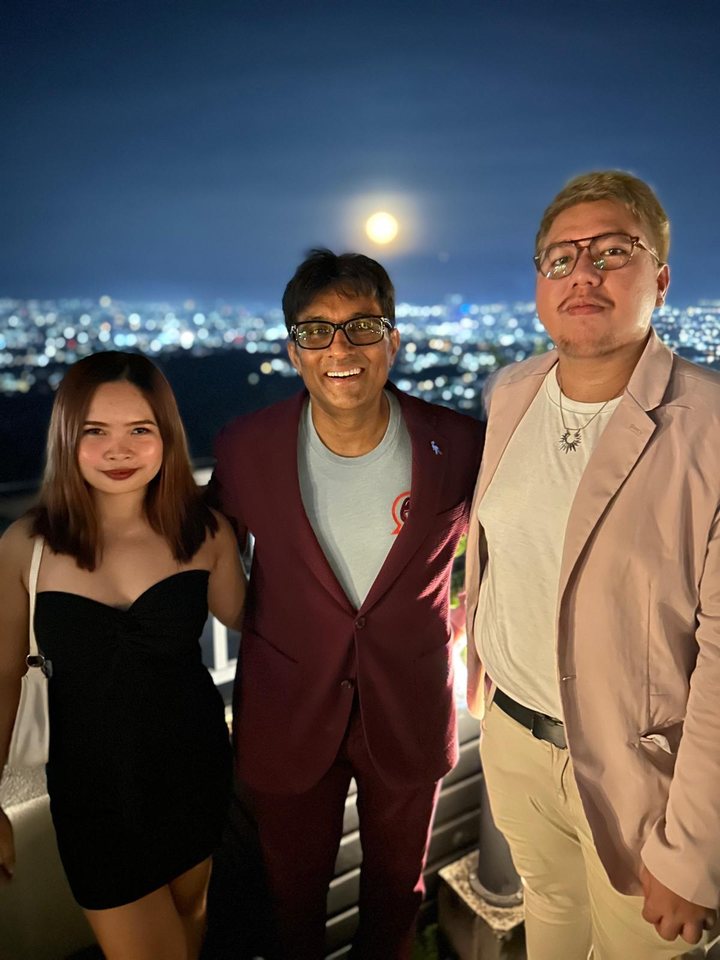 Ask Velma team members with Dr. Rad on a rooftop overlooking the city at night